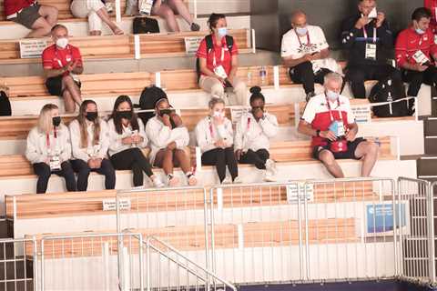 Simone Biles and other teammates cheer on the U.S. men’s gymnasts as they advance.