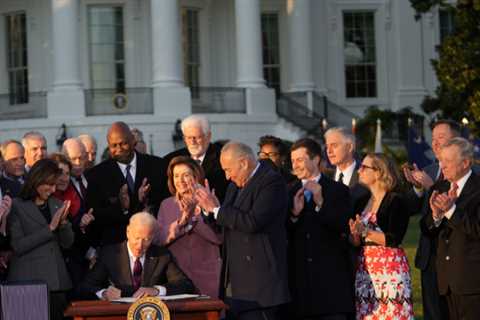 Biden celebrated bipartisanship while signing an infrastructure bill that he claimed would improve..