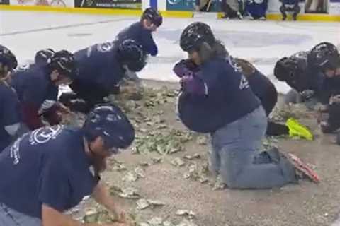 Company Slammed for Making 10 Crawling Teachers Grab for $1 Bills for School Funds During Hockey..