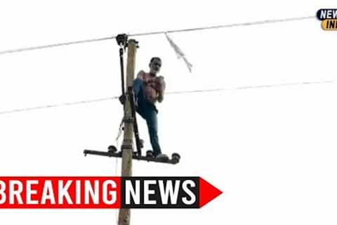 Drunk auto driver climbs atop electric pole after accident to escape public wrath | Watch