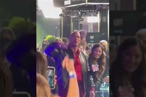 The Rock sings his song along with fans at the red carpet