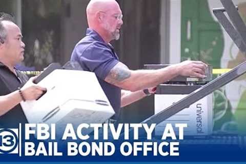 Murder victim's father watches FBI activity at bail bond office
