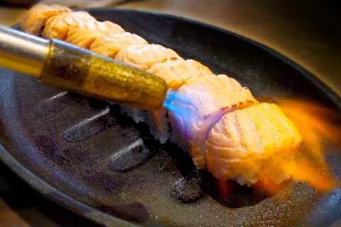 This Sushi Chef's Salmon Roll Technique Is on Fire - Literally!
