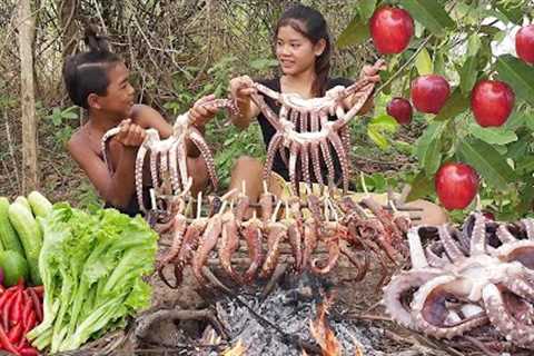 Yummy! Octopus arm spicy roasted and Wild red apple for food - Survival cooking in forest
