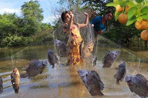 Mother with daughter net fishing in flood forest- Fresh fish soup so delicious for delicious