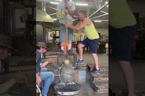 Glass blowing into a mold for a custom lighting project.
