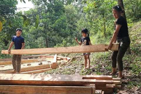 Build. Handmade wooden house. The couple built a wooden house together. in the forest.