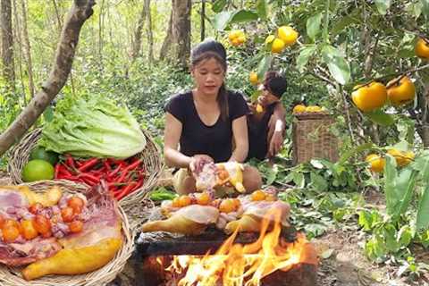 Chicken thigh and egg Cooking on rock with salad, Wild Persimmon fruit for food in jungle