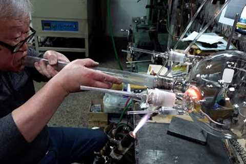 Process of making various glass laboratory equipment. Korean glass blowing master