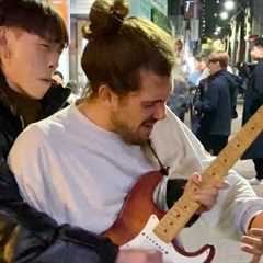 Street performer surprised by guitarist passing by in Korea