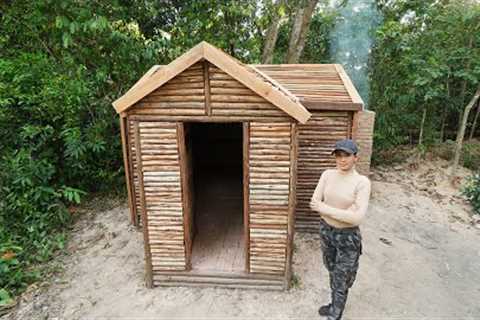 Building Survival Log Cabin Bushcraft Shelter With Wooden Roof , Clay Fireplace In Wilderness