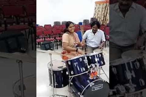 Girl playing drums rolls