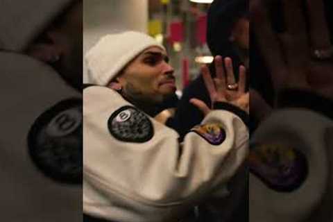 Chris Brown watching Rihanna perform at the Super Bowl