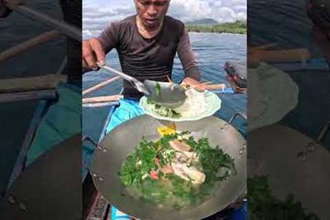 Cooking fresh fish after catch in a boat