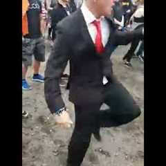 Guy looks out of place wearing a suit to a festival, until the beat drops | CONTENTbible