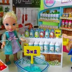 Elsa and Anna toddlers go shopping at the supermarket and buy toys