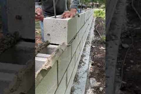 Installing some 8x8x16 CMU blocks for a decretive fence wall