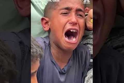 Hungry children struggle for food handouts in Gaza