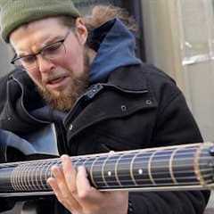 Street musician can't believe the guitar I just handed him