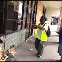 A Man Playing Guitar Is Joined By Two Strangers In An Impromptu Street Performance.